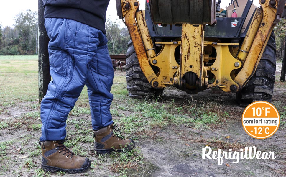 Man standing outside in the cold in front of a tractor wearing Cooler Wear Trousers.