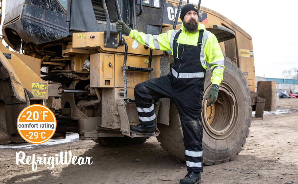 Man outside in the cold wearing Insulated Softshell Enhanced Visibility Bib Overalls